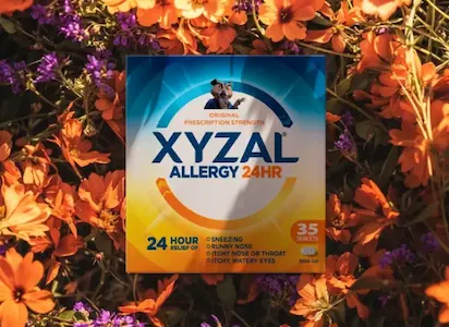 Front of packaging of XYZAL® Allergy 24HR surrounded by flowers.